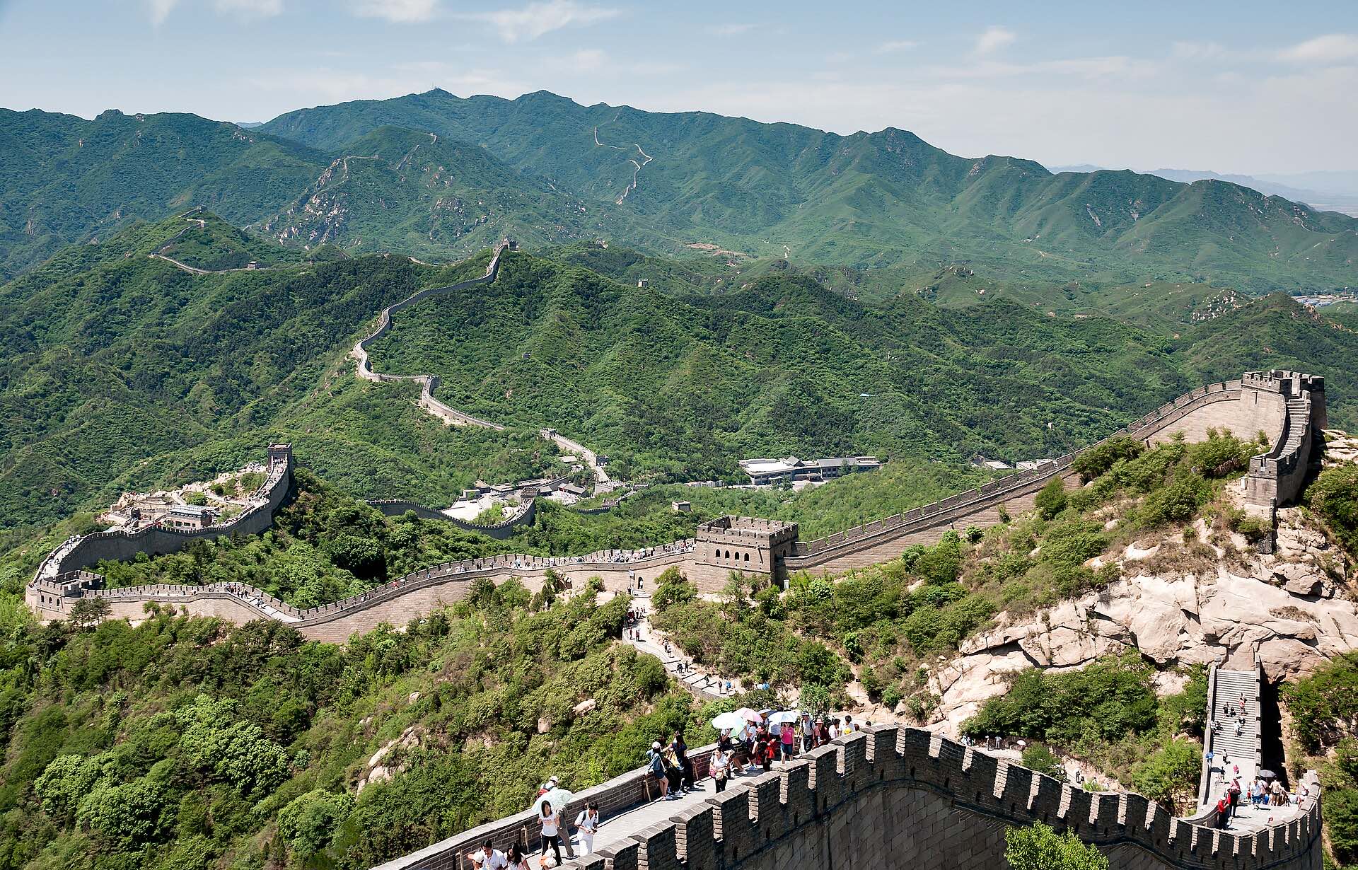 The Great Wall winding over green mountains at Badaling