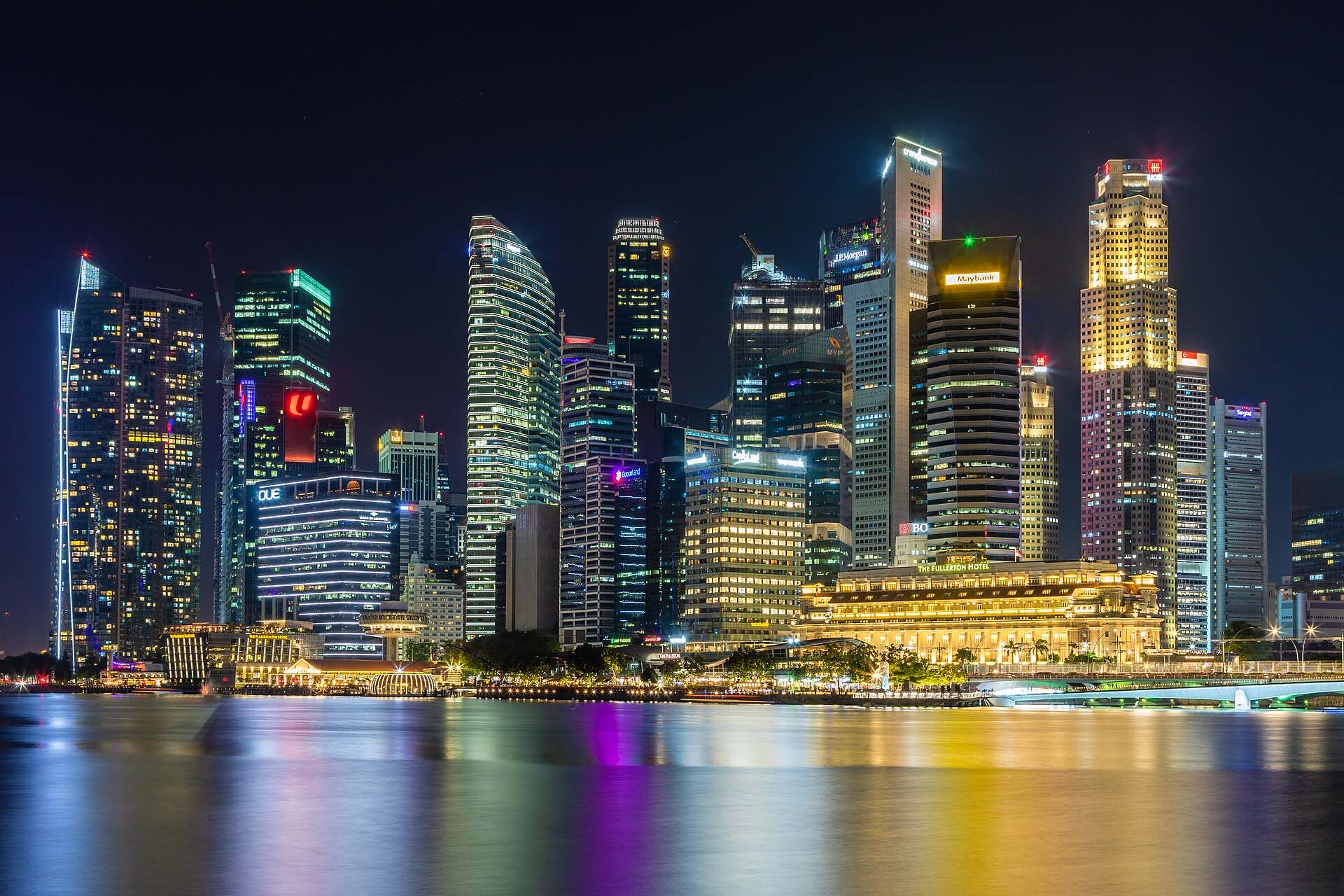 The Singapore skyline at night across Marina Bay
