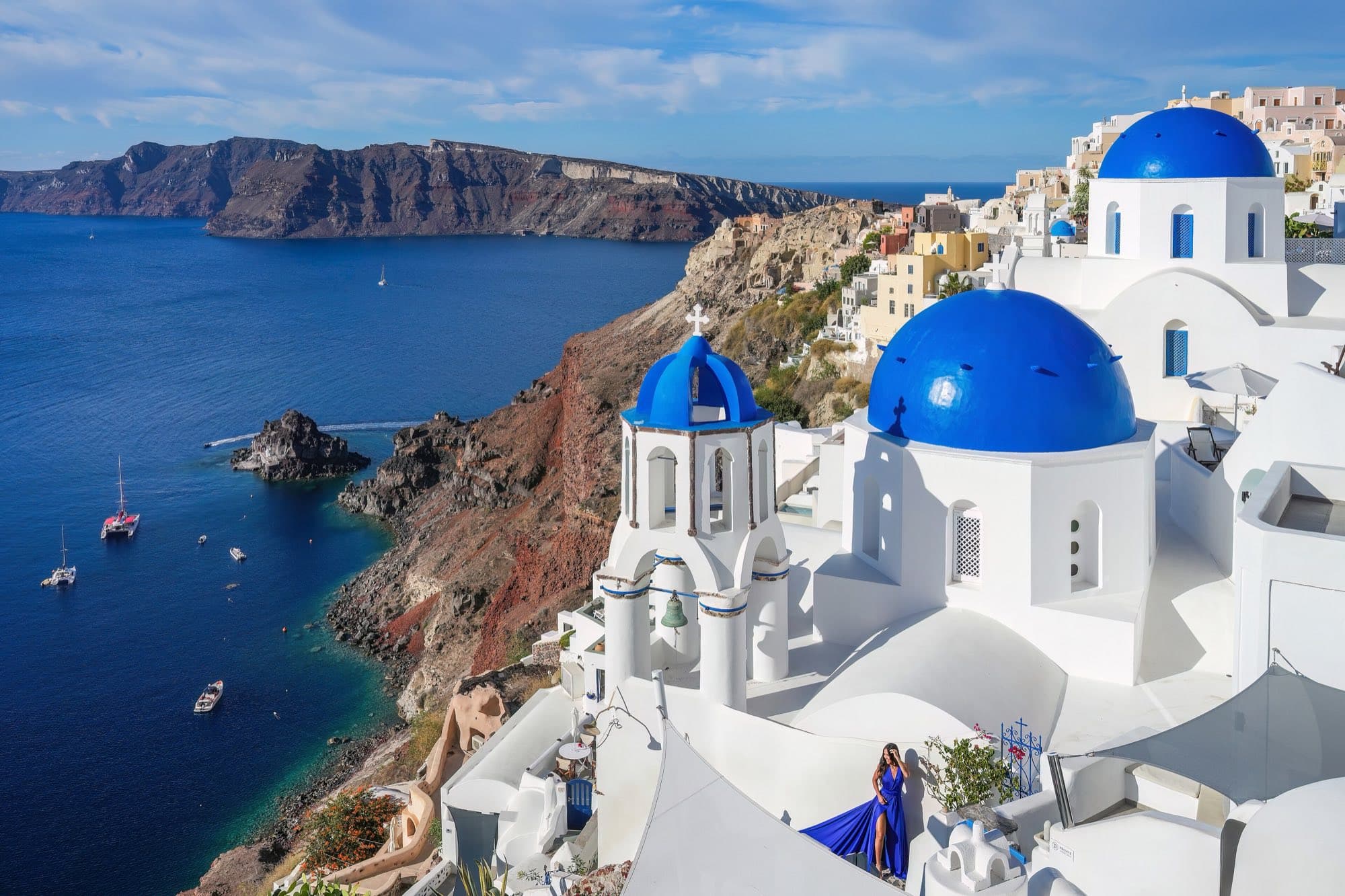 White churches with blue domes above the sea in Oia, Santorini