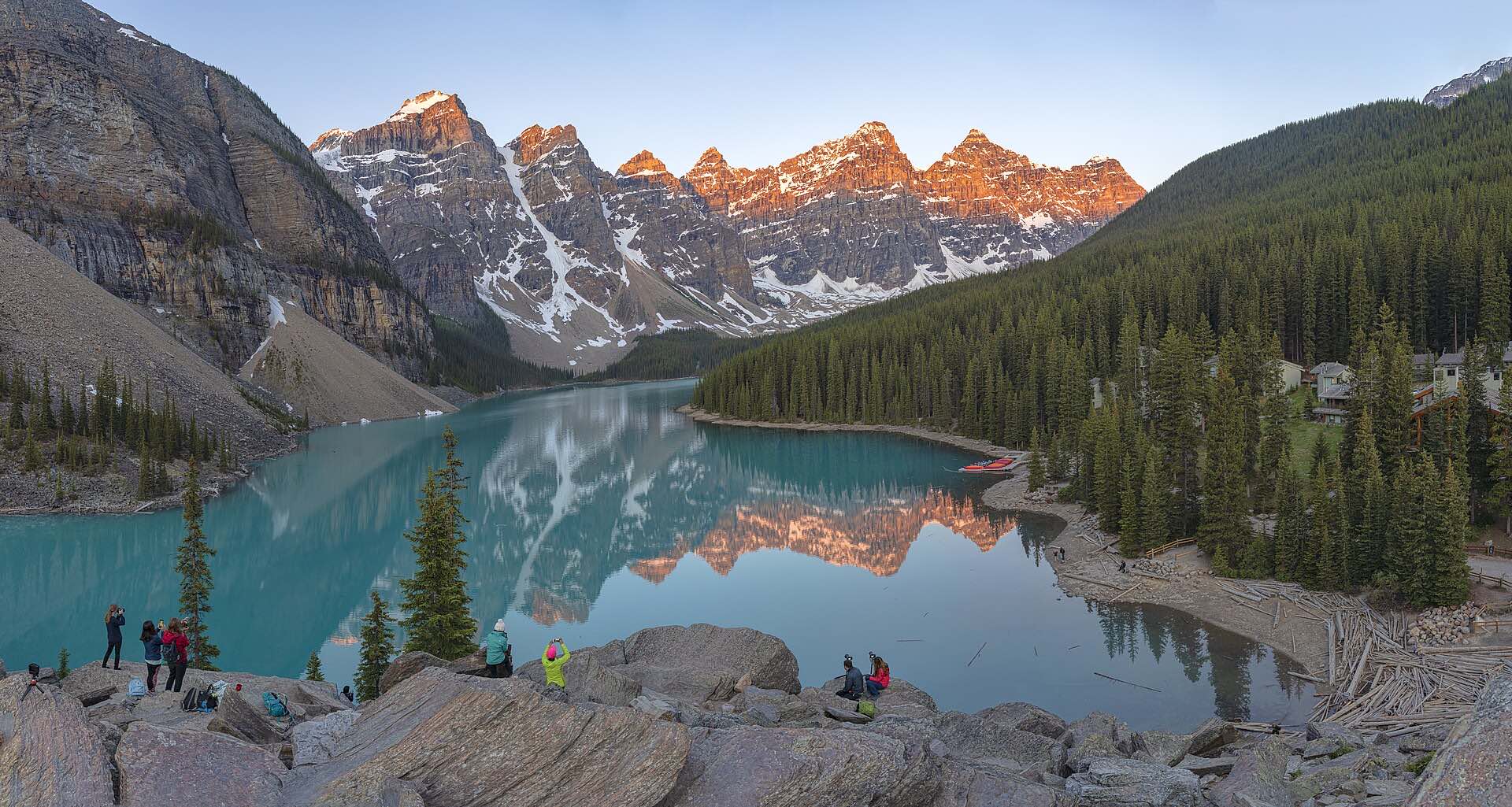 Turquoise Moraine Lake below peaks lit by sunrise