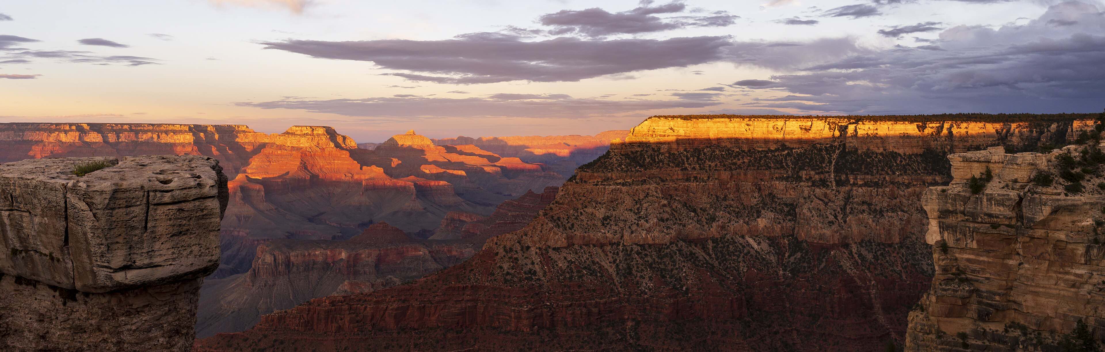 The Grand Canyon's layered cliffs catching the last light at sunset