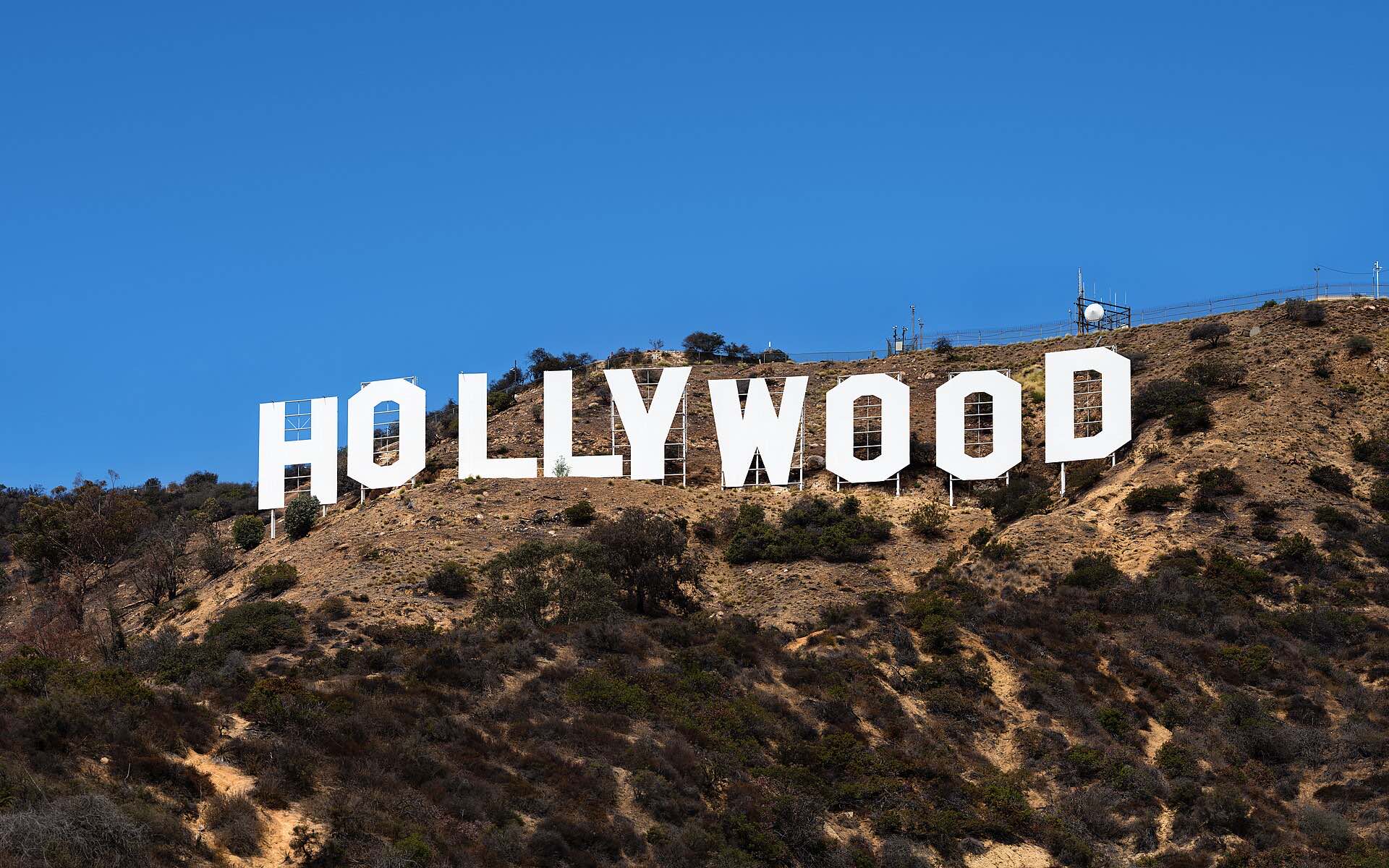 The Hollywood sign on its hillside under a blue sky